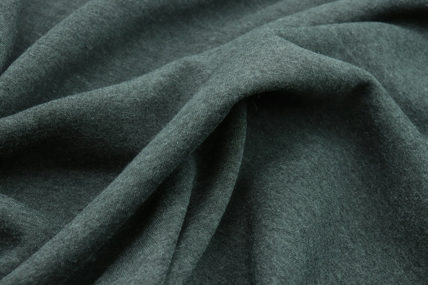 Close-up of dense, dark green brushed wool cloth