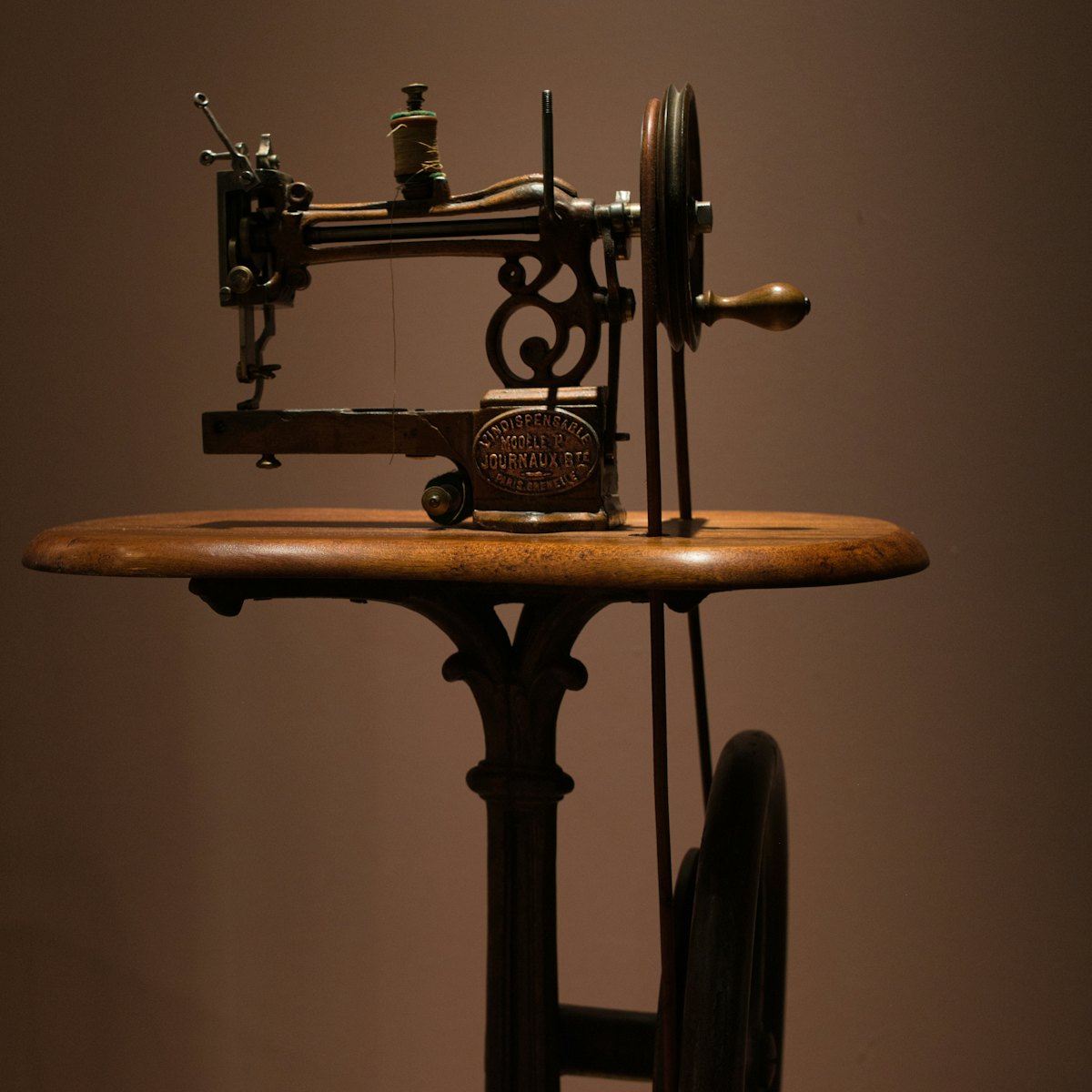 An antique cast-iron sewing machine on a wooden table