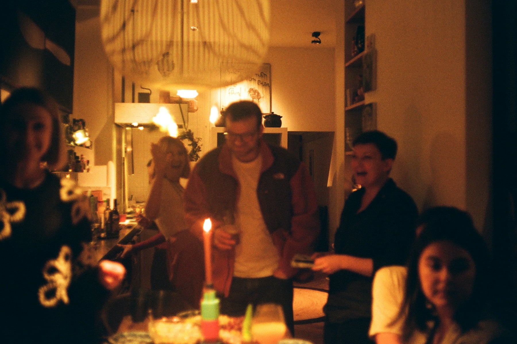 Guests gathered around a candlelit table