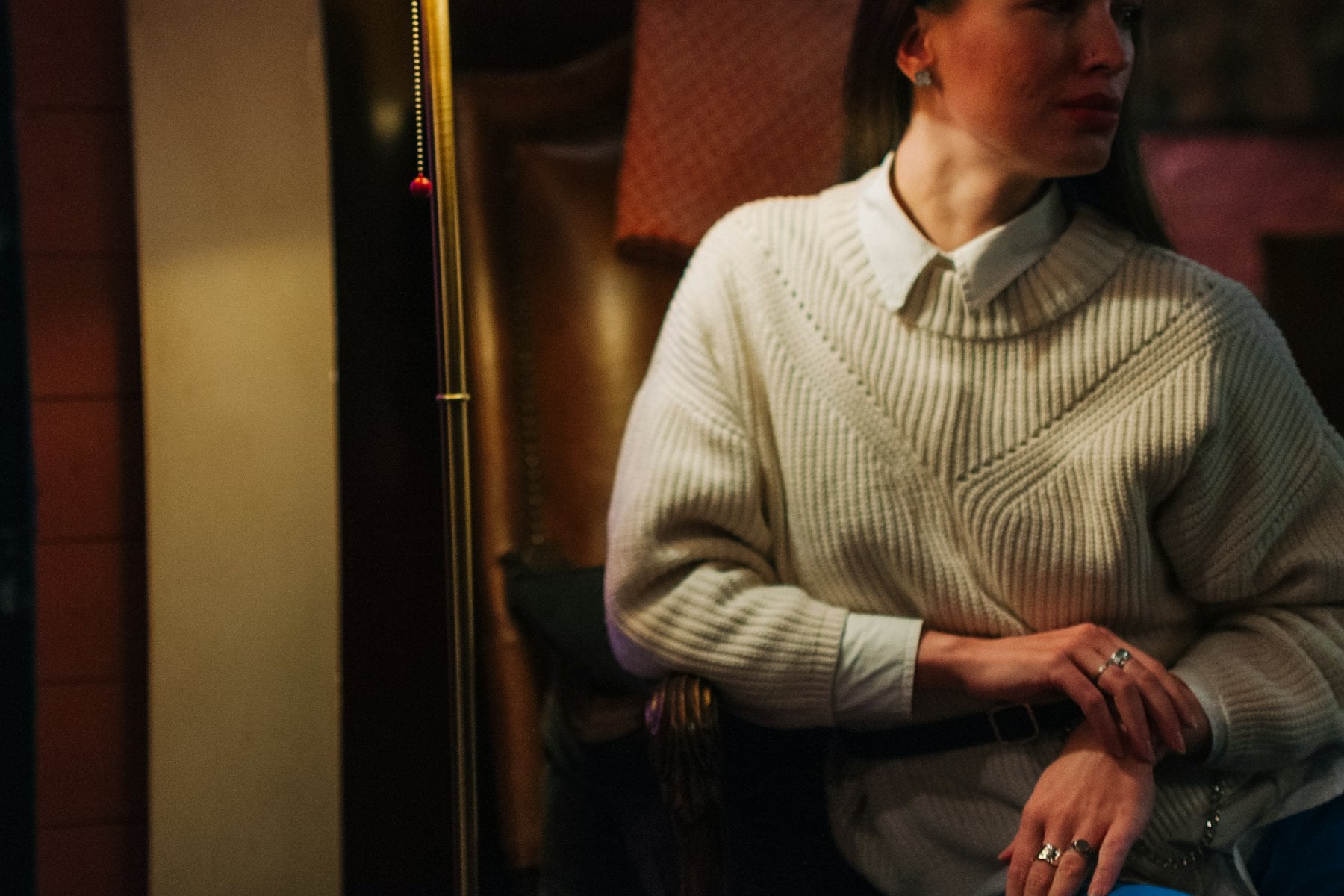 Woman in knitwear by a window
